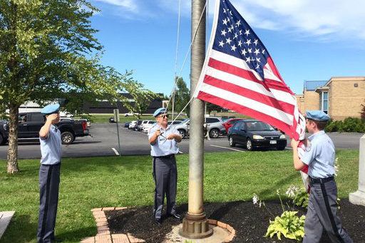 students raising the flag