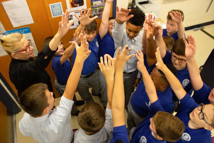 Students raising hands in a cheer