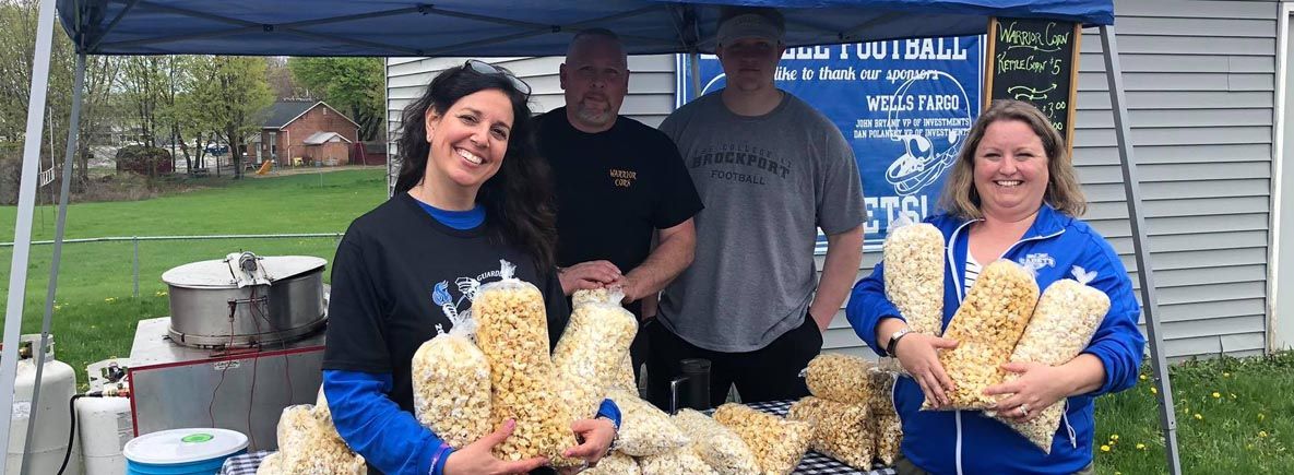Booster Club parents selling popcorn
