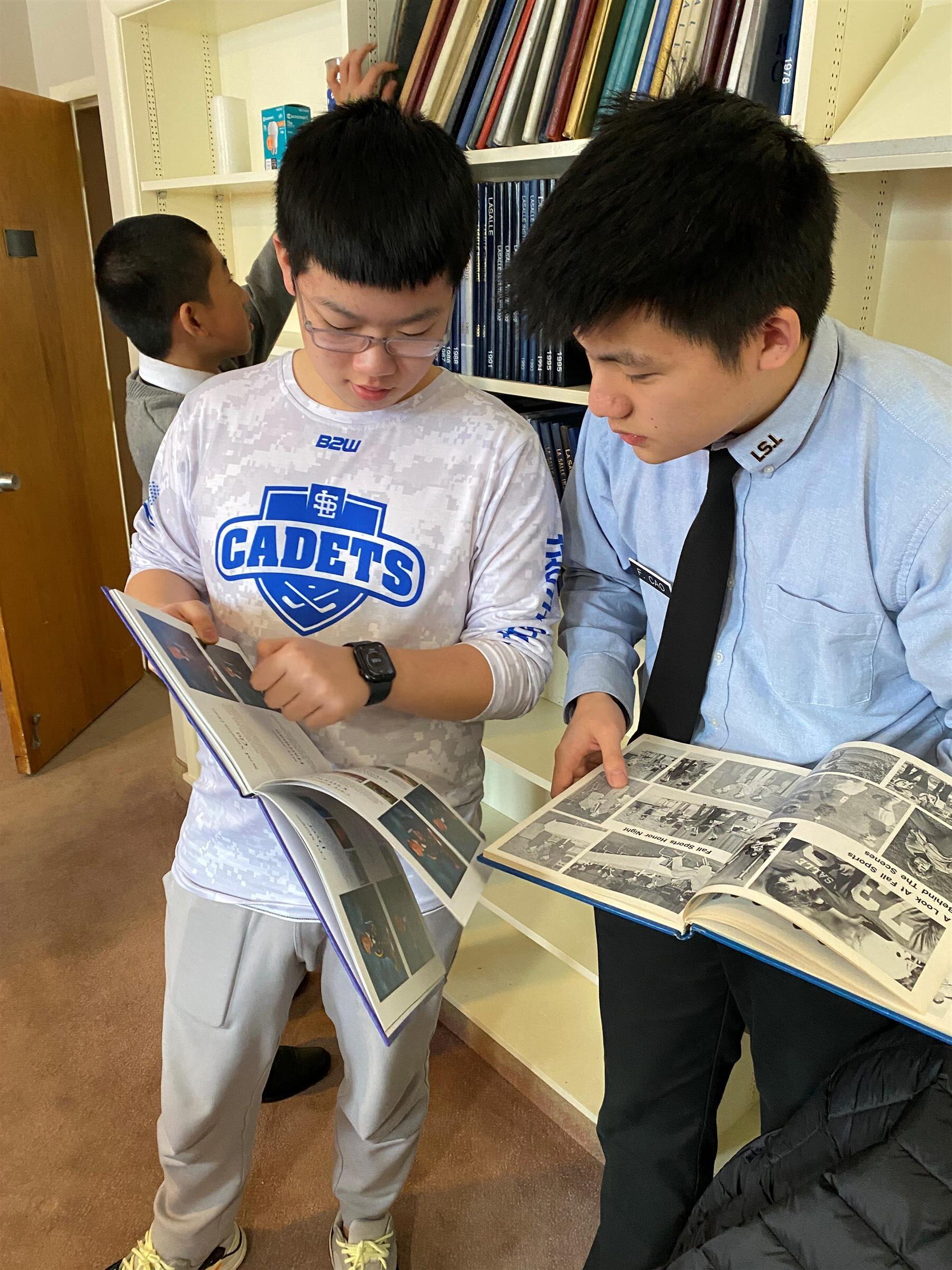 Students looking at old yearbooks