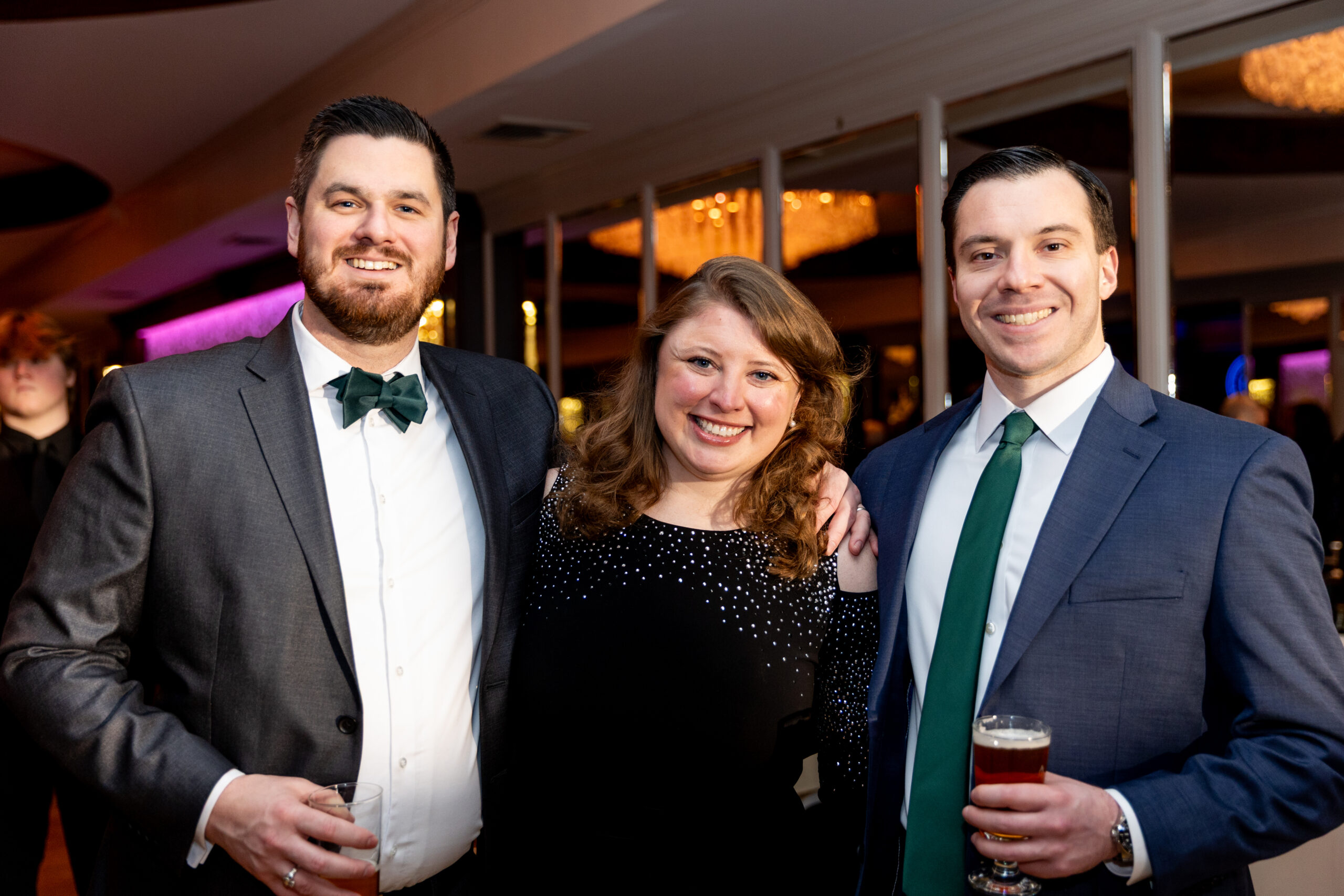 two men and a woman enjoying the gala